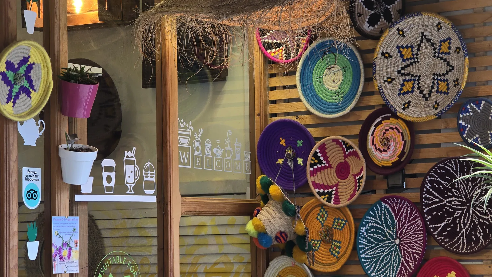 A wall of woven baskets and hanging plants inside Culture Box