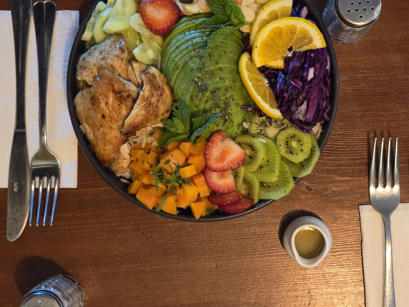 A fresh Culture Box bowl — avocado, chicken, orange, cabbage and kiwi