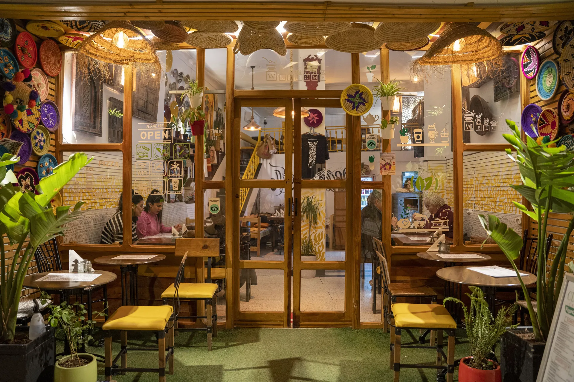 The main dining room of Culture Box — wooden tables, woven lamps and the open doorway