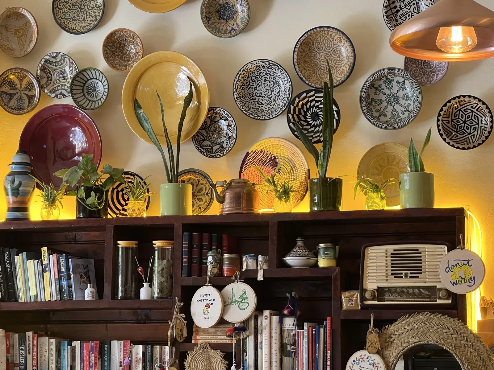 The ceramic plate wall and bookshelf inside Culture Box